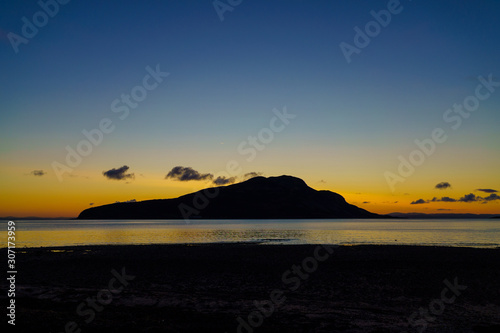 Sunrise over Holy Island from Lamlash on the Isle of Arran in Scotland photo