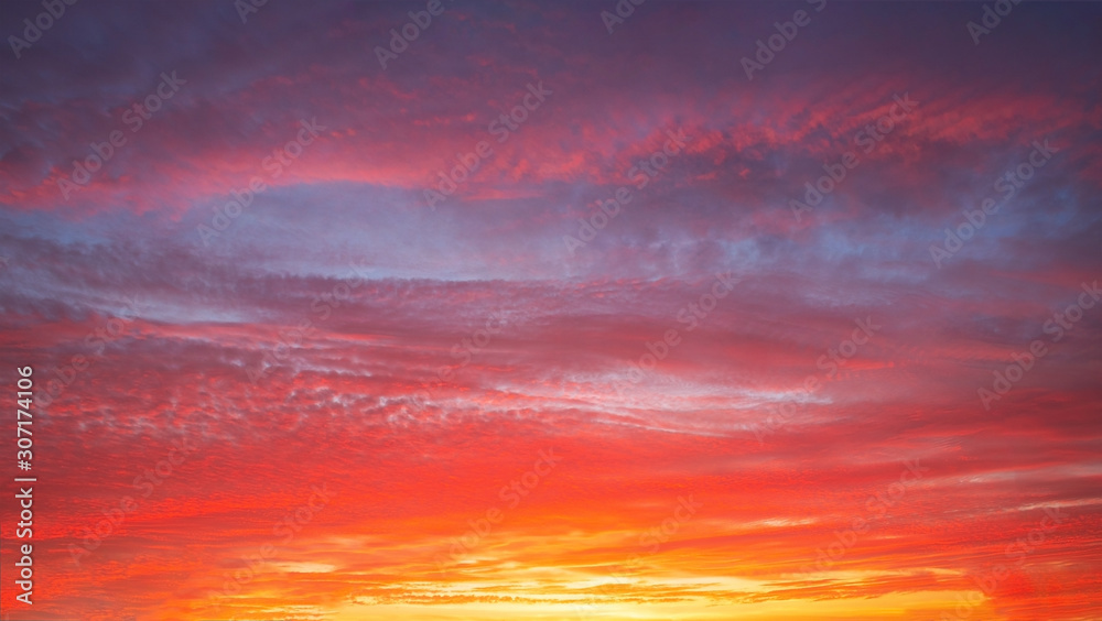 Beautiful bright sunset with multi-colored dramatic clouds