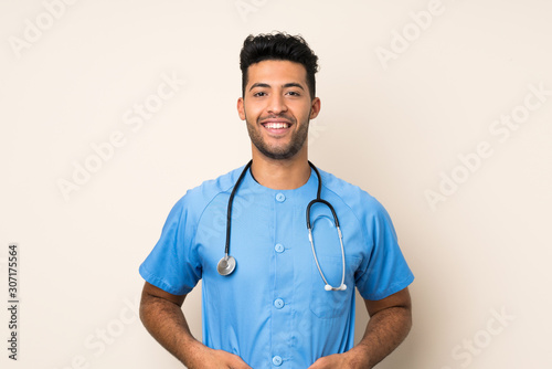 Young handsome man over isolated background with doctor gown