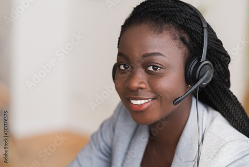Portrait of beautiful black female customer service manager in headset