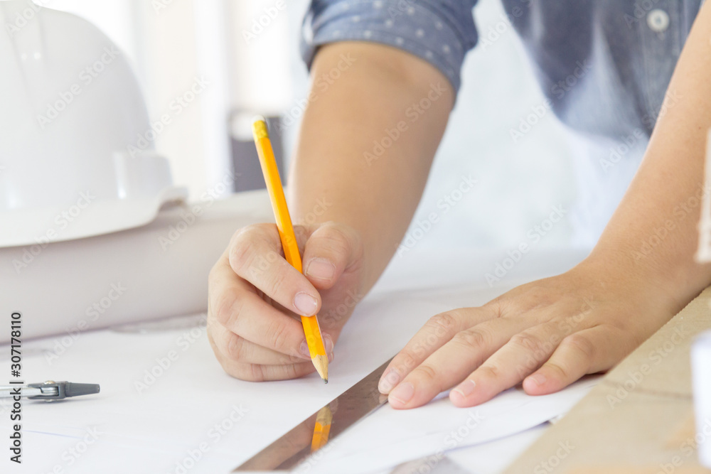 architect working and sketching architectural drawing plan