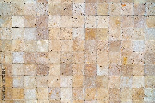 Wall background with Yellow natural sandstone tiles stiched together with clay
