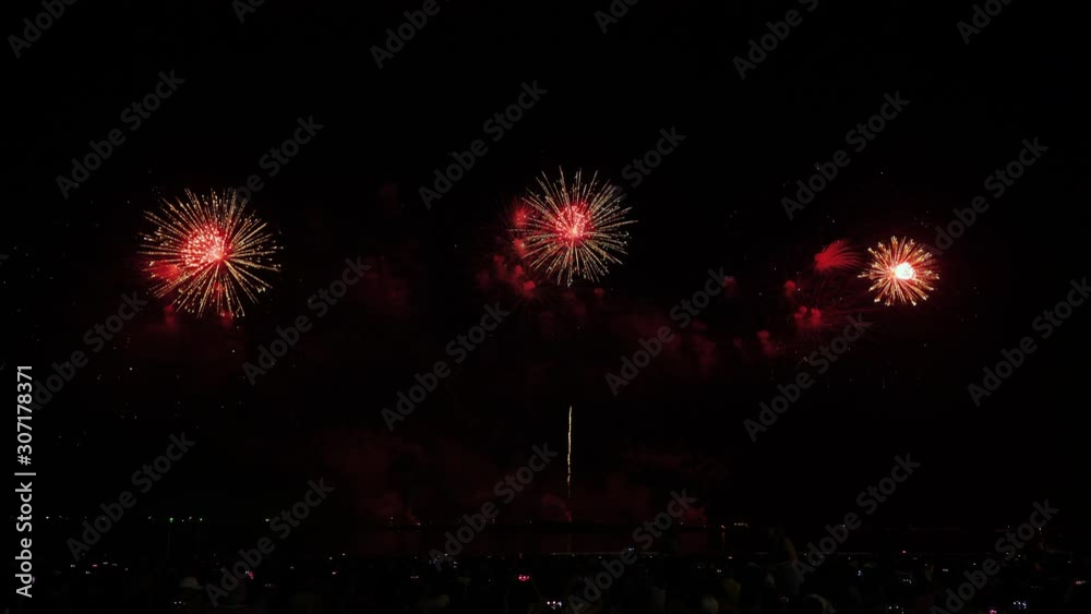 Real fireworks background and people who come to watch on the beach Pattaya International Fireworks Festival. New year's eve fireworks celebration Asia Thailand Real fireworks background and people who come to watch on the beach Pattaya International Fireworks Festival. New year's eve fireworks celebration Asia Thailand