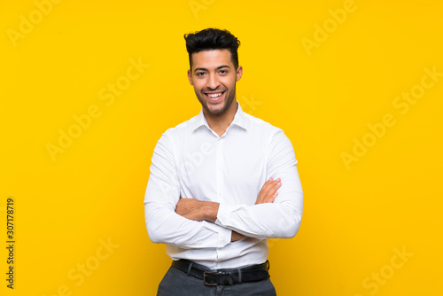 Young handsome man over isolated yellow background laughing