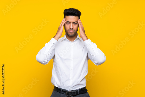 Canvas Print Young handsome man over isolated yellow background unhappy and frustrated with something