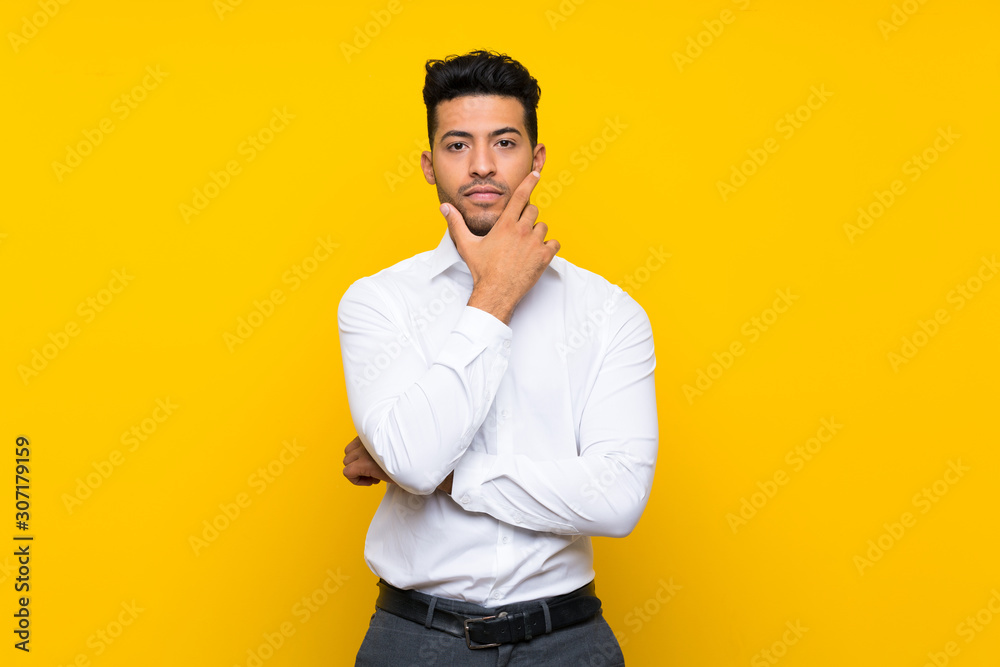 Young handsome man over isolated yellow background thinking an idea Young handsome man over isolated yellow background thinking an idea