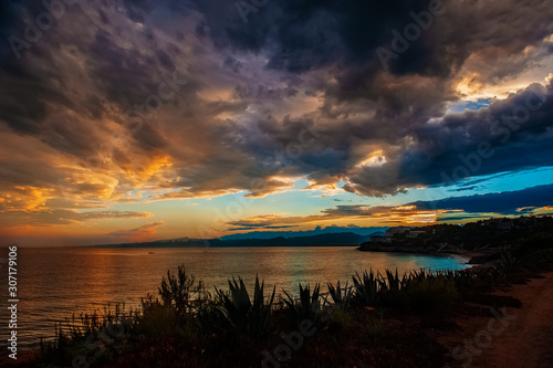 Dramatic sunset over the coastline after a thunderstorm. Nature of Spain, Cape Salou