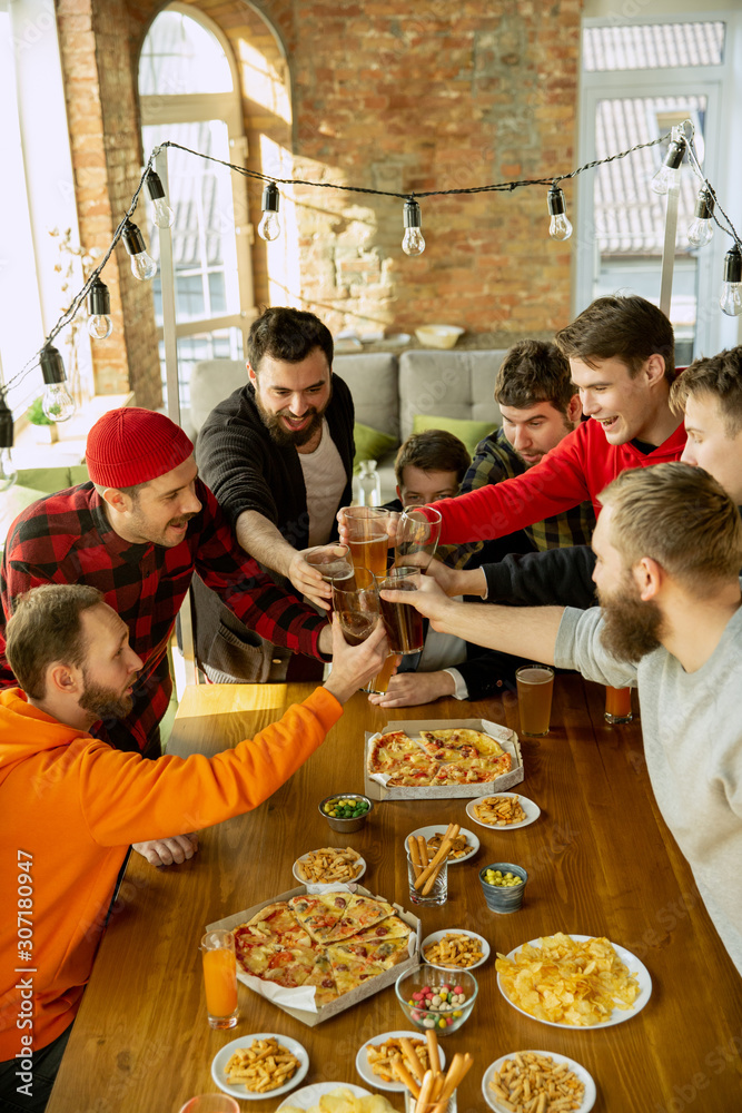 Happy co-workers celebrating while company party and corporate event. Young caucasian people in casual clothes cheering and laughting. Concept of office culture, teamwork, friendship, holidays Happy co-workers celebrating while company party and corporate event. Young caucasian people in casual clothes cheering and laughting. Concept of office culture, teamwork, friendship, holidays