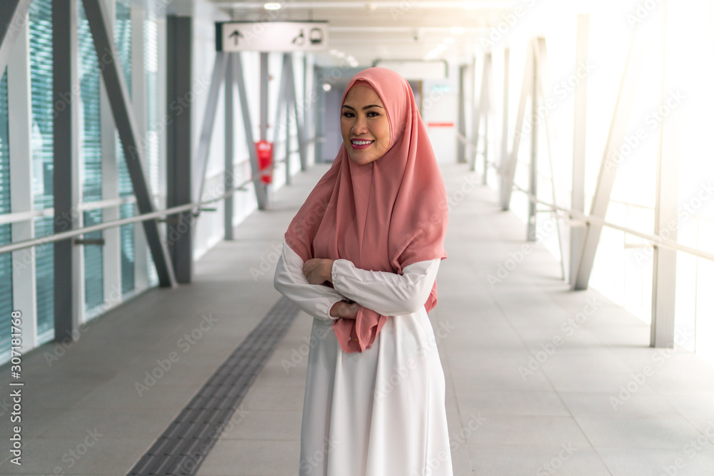 Asian Muslim Lady at the train station wearing hijab Asian Muslim Lady at the train station wearing hijab