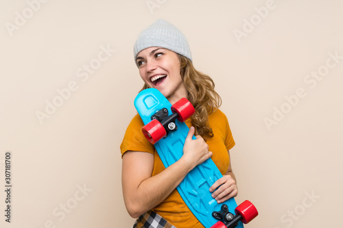 Young skater blonde girl over isolated background