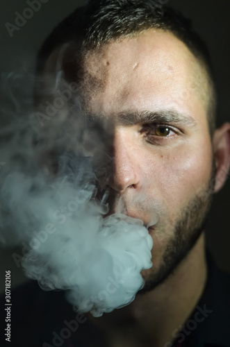 Man smoking electronic cigarette and Making Smoke Rings