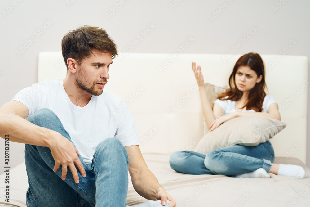 young couple sitting on sofa watching tv young couple sitting on sofa watching tv