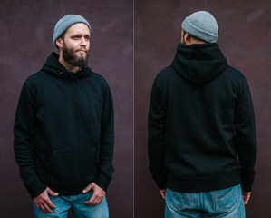 City portrait of handsome hipster man with beard wearing black blank hoodie or sweatshirt with space for your logo or design. Front and back view mockup of black hoodie