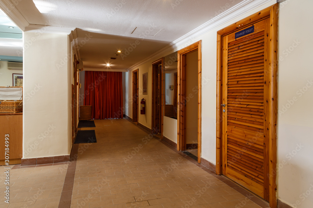 interior of the modern Spa center with hall, tables, chairs, corridors, beautiful design of dark wood. Europe Greece interior of the modern Spa center with hall, tables, chairs, corridors, beautiful design of dark wood. Europe Greece