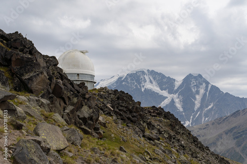 the old Observatory on the background of rocky mountains with snow. The Caucasus. Russia. photo