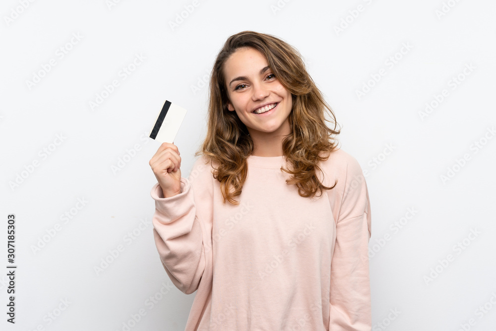 Young blonde woman holding a credit card Young blonde woman holding a credit card