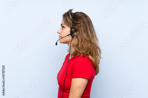 Young blonde woman working with headset