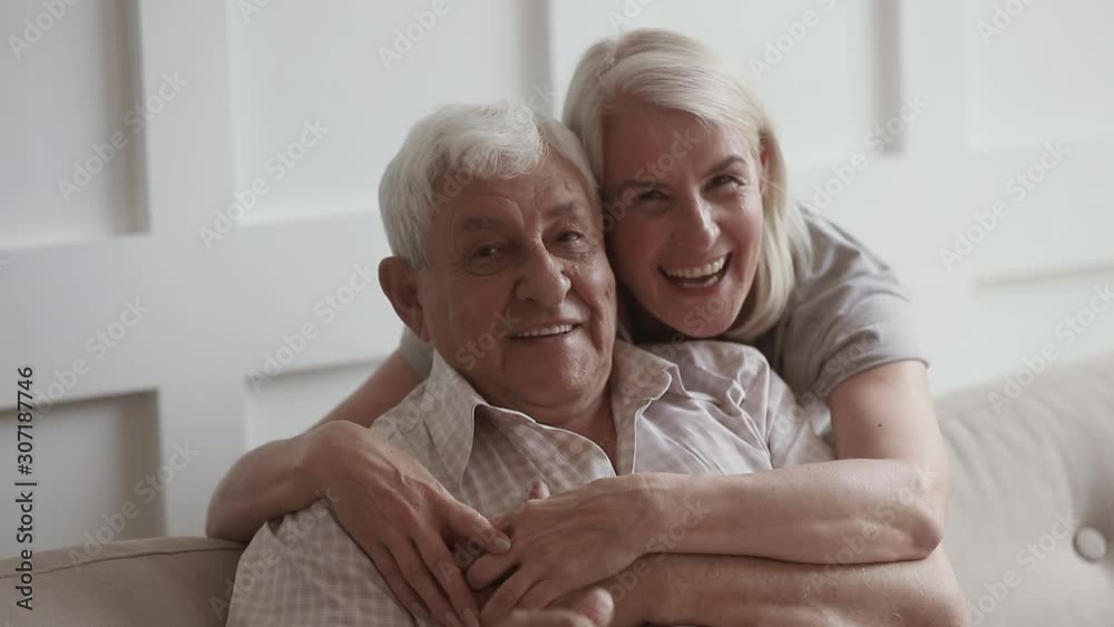Smiling middle aged woman hugging happy 80s retired father. Smiling middle aged woman hugging happy 80s retired father.