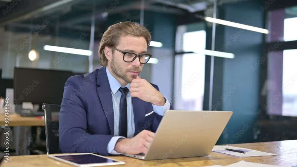 Pensive Businessman Thinking and working on Laptop Pensive Businessman Thinking and working on Laptop