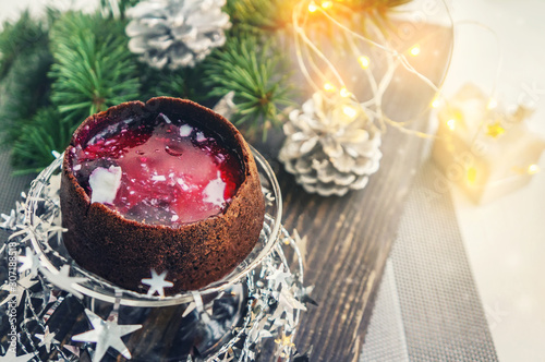 Chocolate cupcakes stuffed with berry jam on the Christmas table