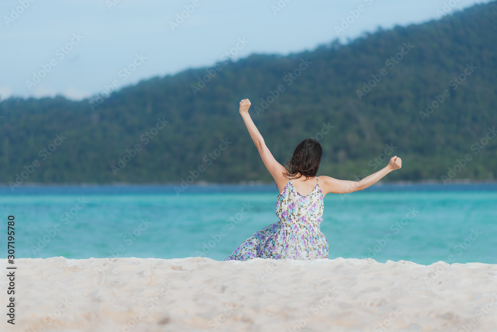Back view of woman enjoying travel at the sea with freedom pose Back view of woman enjoying travel at the sea with freedom pose