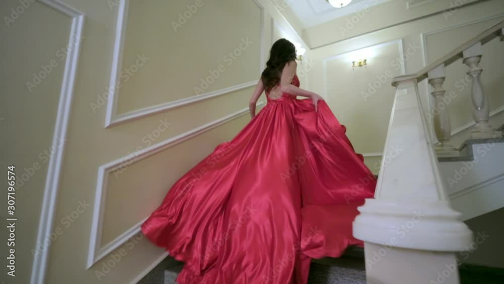 Beautiful woman in a red dress posing. Fashion and style concept.
