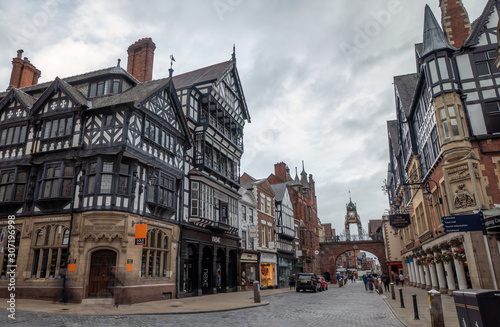 9 August 2019: Chester, Cheshire, England, UK - Half timbered houses in Bridge Street in cloudy day photo
