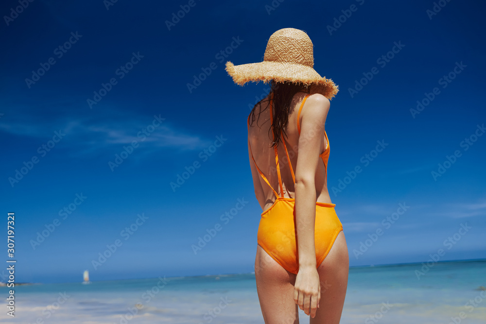 young woman in hat on the beach