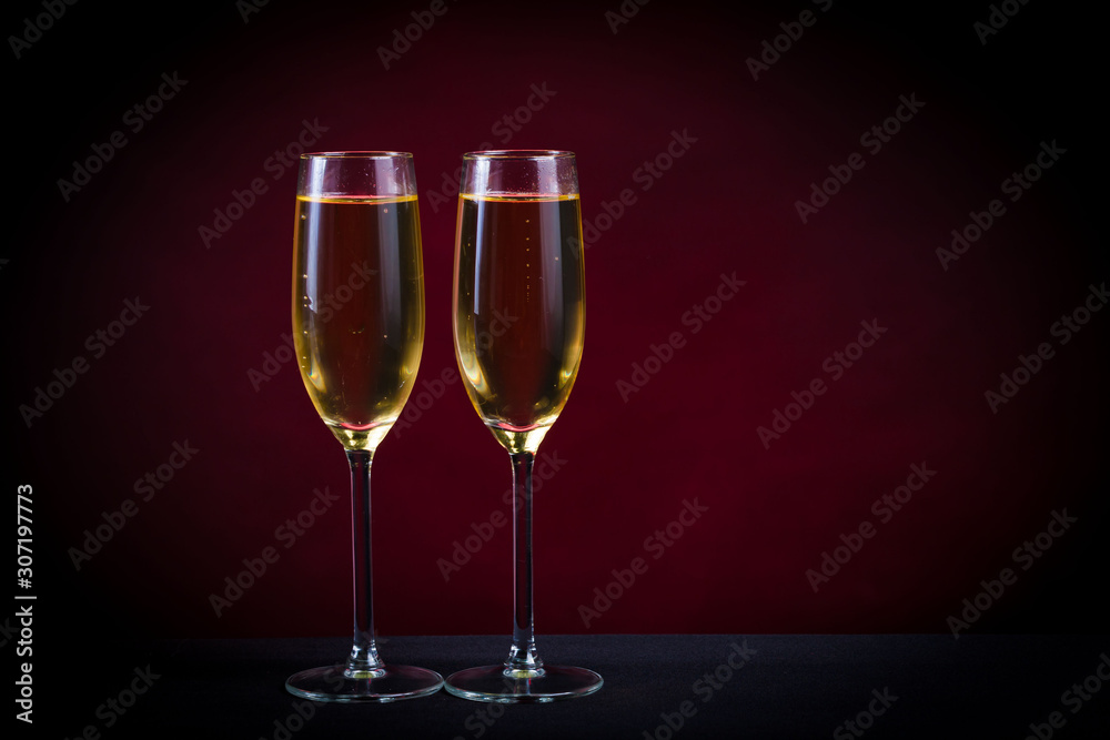 Drink. Two glasses white wine, dark background