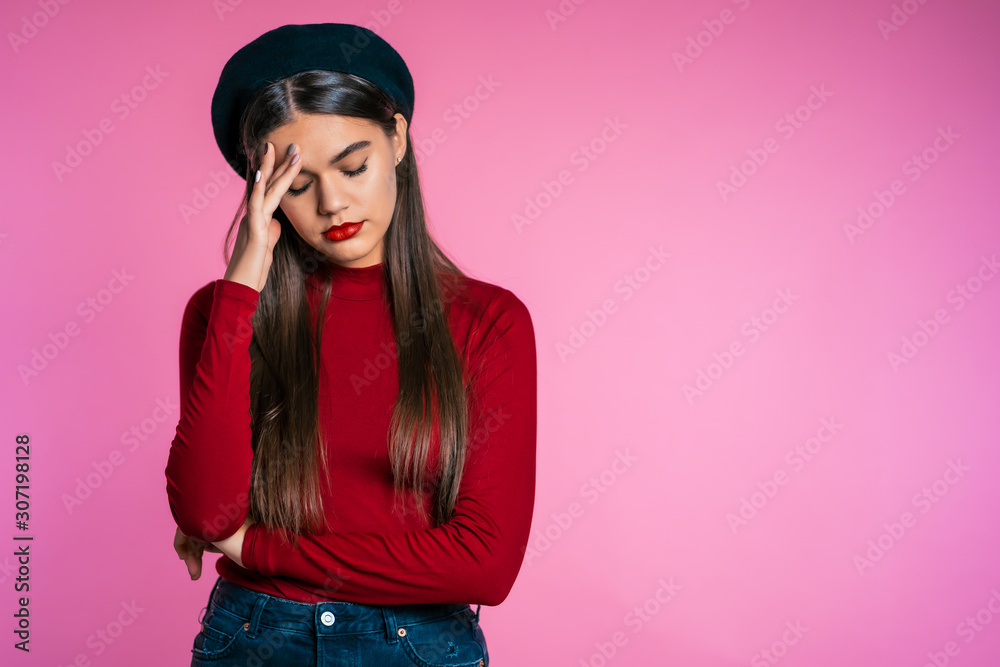 Young woman having headache, studio portrait. Girl putting hand on head, displeased rolling eyes. isolated on pink background. Concept of problems, depression. Young woman having headache, studio portrait. Girl putting hand on head, displeased rolling eyes. isolated on pink background. Concept of problems, depression.