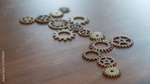 Connecting gears on wooden table. Fulfill and fix the problem of incomplete teamwork.