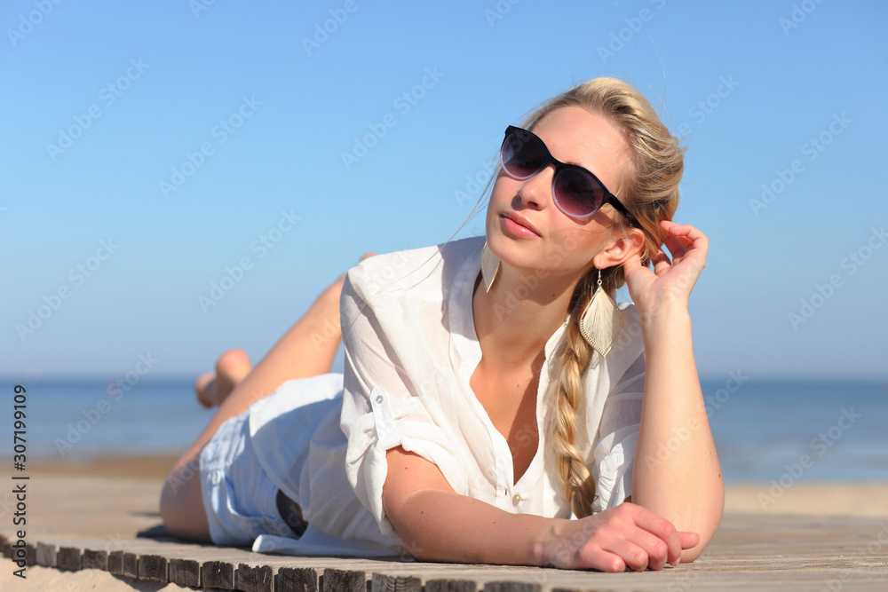 Girl in sunglasses on background of sky