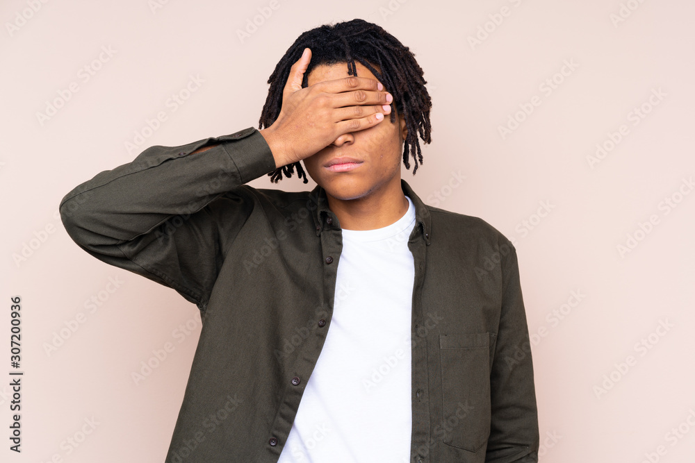 Young African American man over isolated background covering eyes by hands. Do not want to see something Young African American man over isolated background covering eyes by hands. Do not want to see something