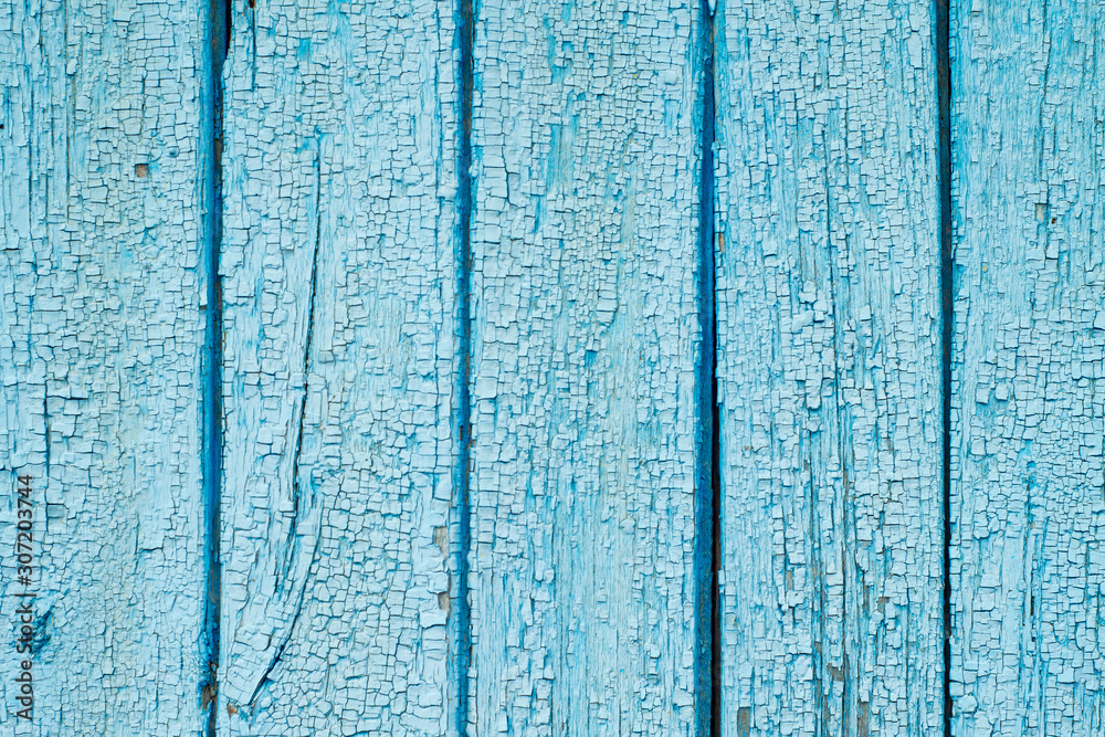 Aged painted cracked boards with blue color peeling paint. Old natural grunge textured wooden texture. Weathered wood wall for design closeup. Rustic background Aged painted cracked boards with blue color peeling paint. Old natural grunge textured wooden texture. Weathered wood wall for design closeup. Rustic background