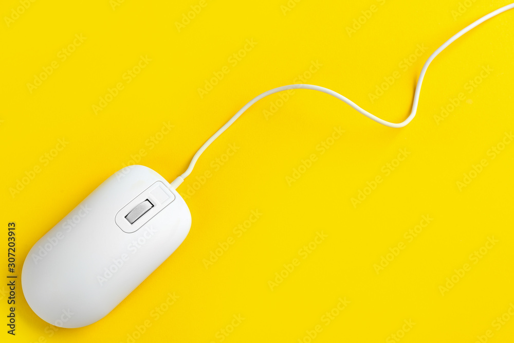 Modern wired optical mouse on yellow background, top view. Space for text Modern wired optical mouse on yellow background, top view. Space for text