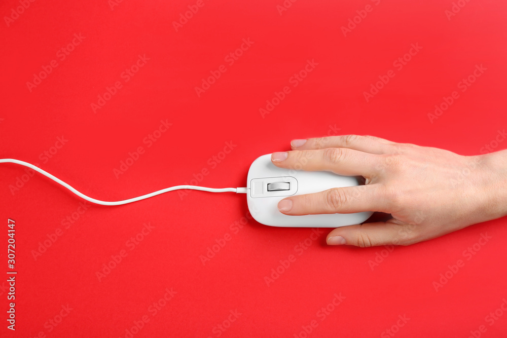 Woman using modern wired optical mouse on red background, top view Woman using modern wired optical mouse on red background, top view