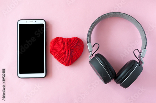 headphones, smartphone andred heart. Top view photo