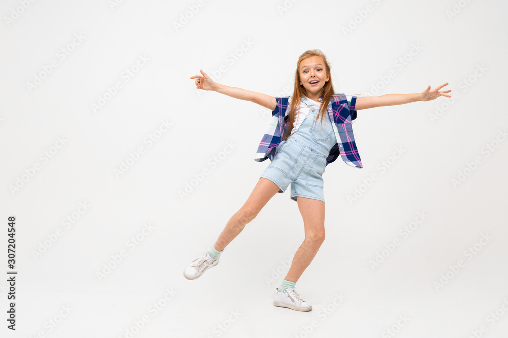 attractive european girl jumping on a white background with copyspace