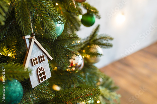 christmas toy wood house on fir branch , new year scandinavian decoration