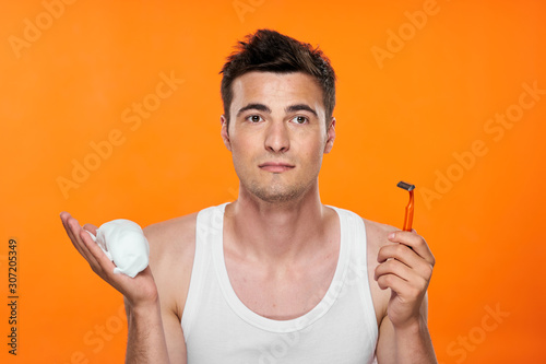 portrait of man with baseball bat on green background