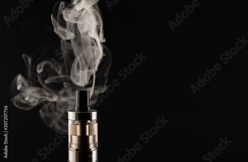 VAPE, electronic cigarette soaring, Smoking on a black background.