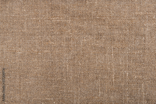 Burlap material. Rural sackcloth texture. Background from a very rough, fabric woven from linen, jute or hemp. Design element.