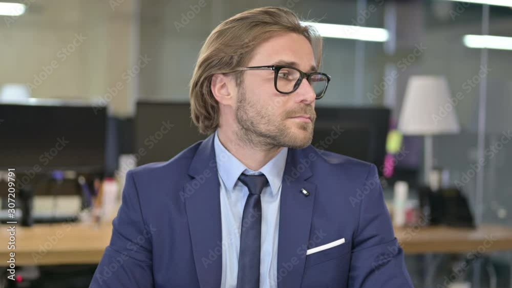 Portrait of Waiting Businessman Checking Time on Watch