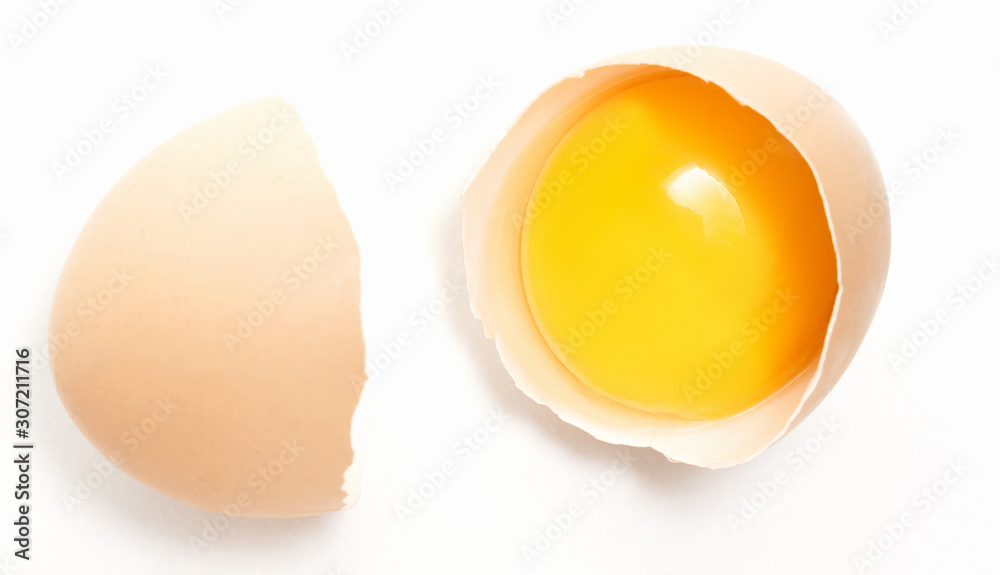 broken chicken egg with yolk in one half of the shell broken chicken egg with yolk in one half of the shell