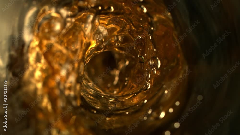 Super Slow Motion Abstract Shot of Pouring Golden Liquid in Glass Bottle at 1000 fps. Filmed with High Speed Cinema Camera in 4K Resolution Super Slow Motion Abstract Shot of Pouring Golden Liquid in Glass Bottle at 1000 fps. Filmed with High Speed Cinema Camera in 4K Resolution