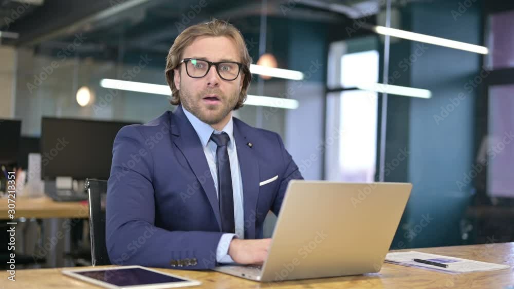Shocked Businessman Wondering while Looking at Camera Shocked Businessman Wondering while Looking at Camera