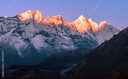 Delightful row of majestic peaks in the first rays of the rising sun. Magical magnificent sunrise in Solukhumbu valley in Himalayan mountains; trekking to Everest base camp, Nepal