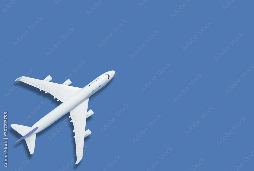 Flat lay of miniature toy airplane on blue background minimal trip and travel creative concepts. copy space Flat lay of miniature toy airplane on blue background minimal trip and travel creative concepts. copy space
