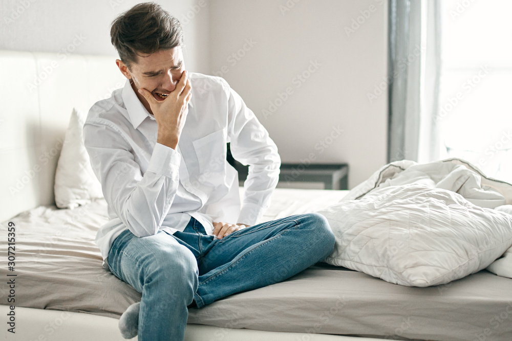 man sitting on sofa at home man sitting on sofa at home