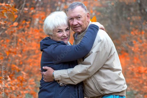 Senior man and woman hugging in an autumn park © AnastazjaSoroka